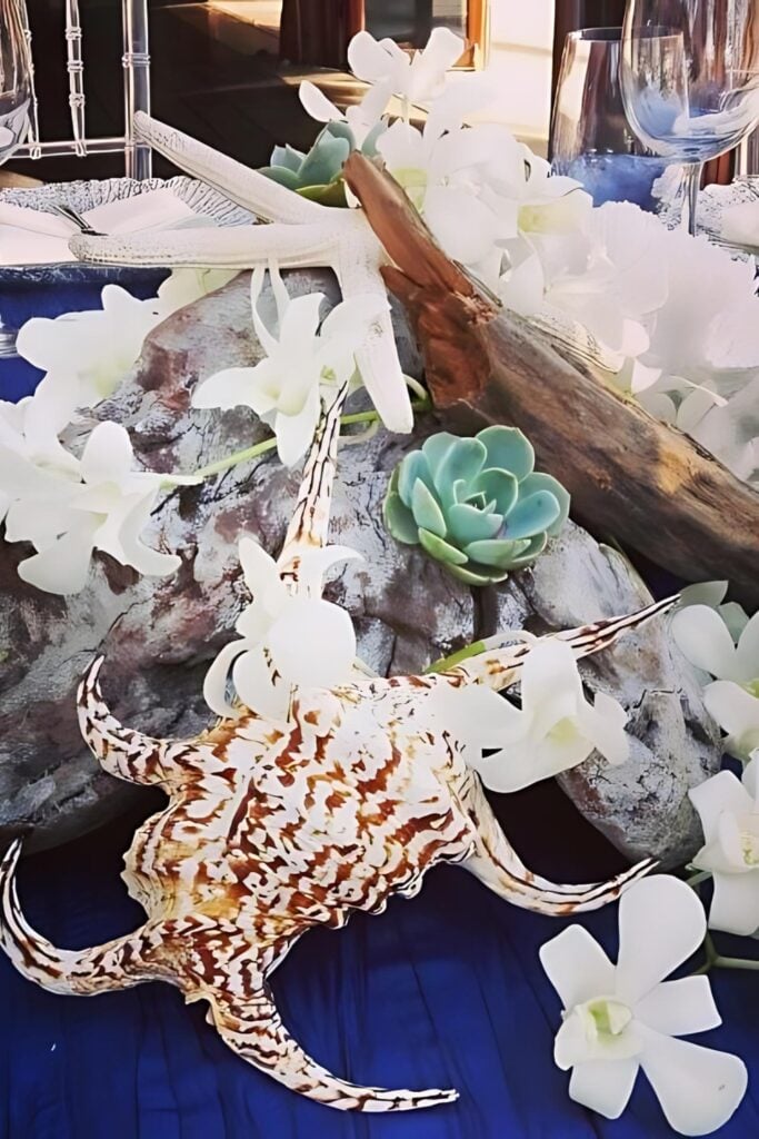 Succulent, white florals and beach elements wedding centerpiece