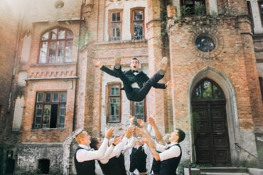 groomsmen and groom in wedding suits