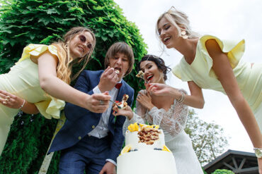 Groom and Bride Eating Cake and Having Fun